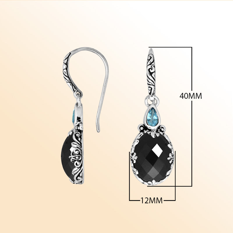 Sterling silver earrings featuring a striking Black Onyx teardrop paired with a sparkling Blue Topaz Quartz accent and ornate carved detailing for bold, expressive everyday elegance.