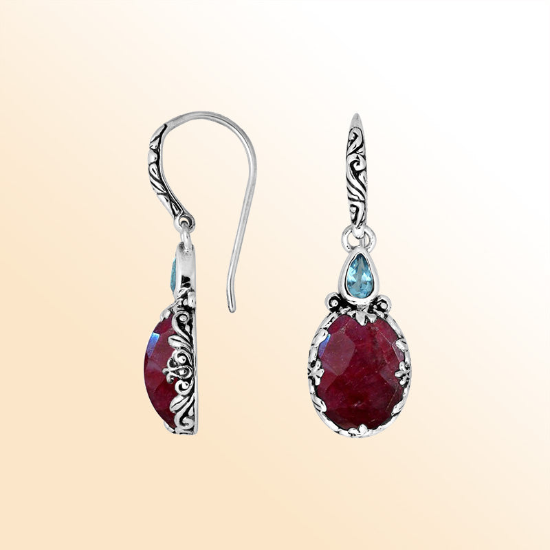 Sterling silver earrings featuring a vivid Ruby Quartz teardrop paired with a sparkling Blue Topaz Quartz accent and carved detailing for bold, vibrant everyday elegance.
