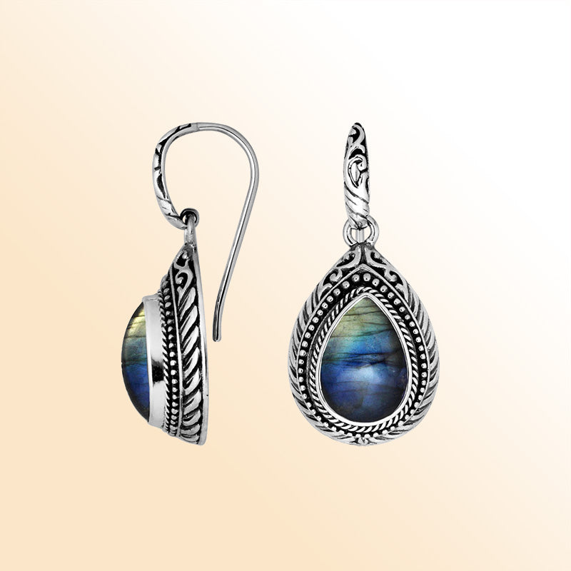 Sterling silver Labradorite teardrop earrings with handcrafted carved silver frame, decorative bead accents, antique-polished finish, and elegant earwire hooks designed for refined everyday and occasion wear.