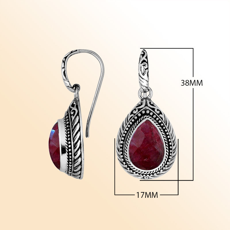 Sterling silver Ruby Quartz teardrop earrings with handcrafted carved silver frame, decorative bead accents, antique-polished finish, and elegant earwire hooks designed for refined everyday and special occasion wear.