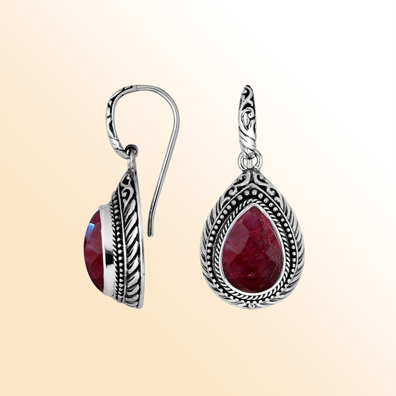 Sterling silver Ruby Quartz teardrop earrings with handcrafted carved silver frame, decorative bead accents, antique-polished finish, and elegant earwire hooks designed for refined everyday and special occasion wear.
