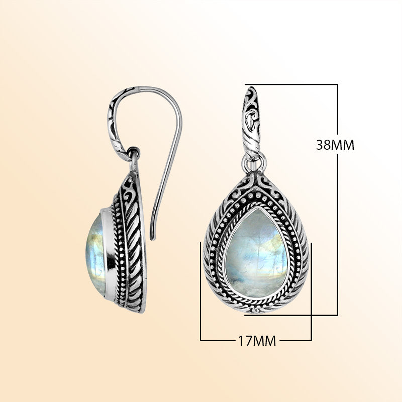 Sterling silver Rainbow Moonstone teardrop earrings with handcrafted carved silver frame, decorative bead accents, antique-polished finish, and elegant earwire hooks designed for refined everyday and special occasion wear.