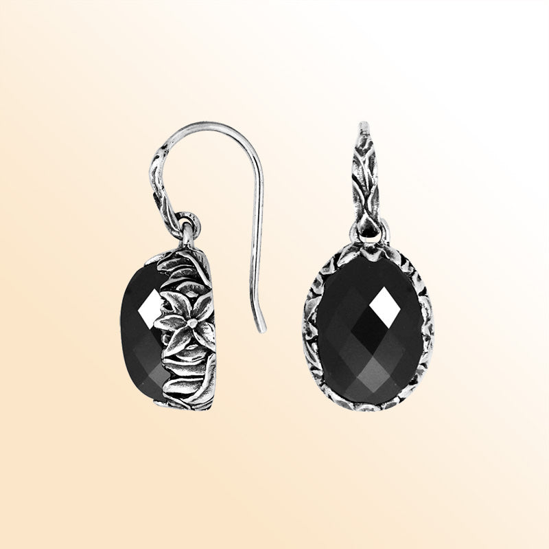 Sterling silver Black Onyx oval earwire earrings featuring handcrafted floral silver detailing, polished oxidized finish, bold black stone shine, and elegant drop design suitable for refined everyday and evening wear.