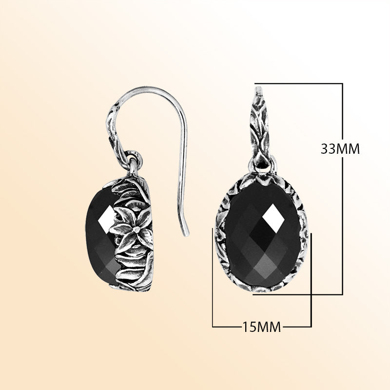Sterling silver Black Onyx oval earwire earrings featuring handcrafted floral silver detailing, polished oxidized finish, bold black stone shine, and elegant drop design suitable for refined everyday and evening wear.
