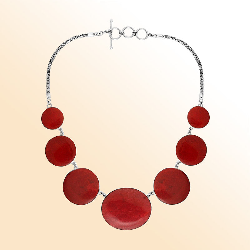 Women’s sterling silver necklace with polished coral discs and Bali-inspired accents.