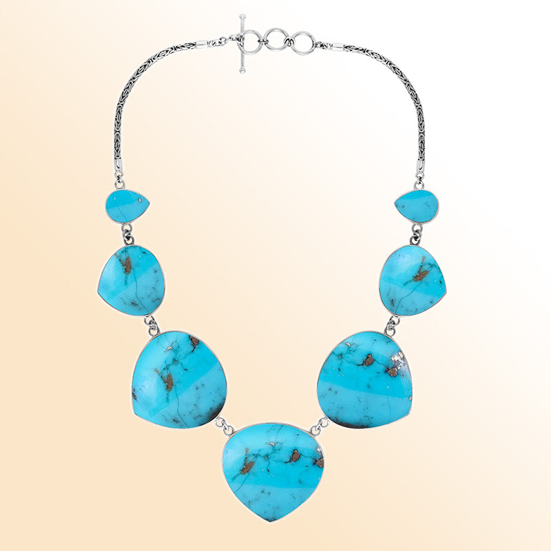 Women’s sterling silver necklace with heart-shape turquoise shell stones and Bali-inspired accents.