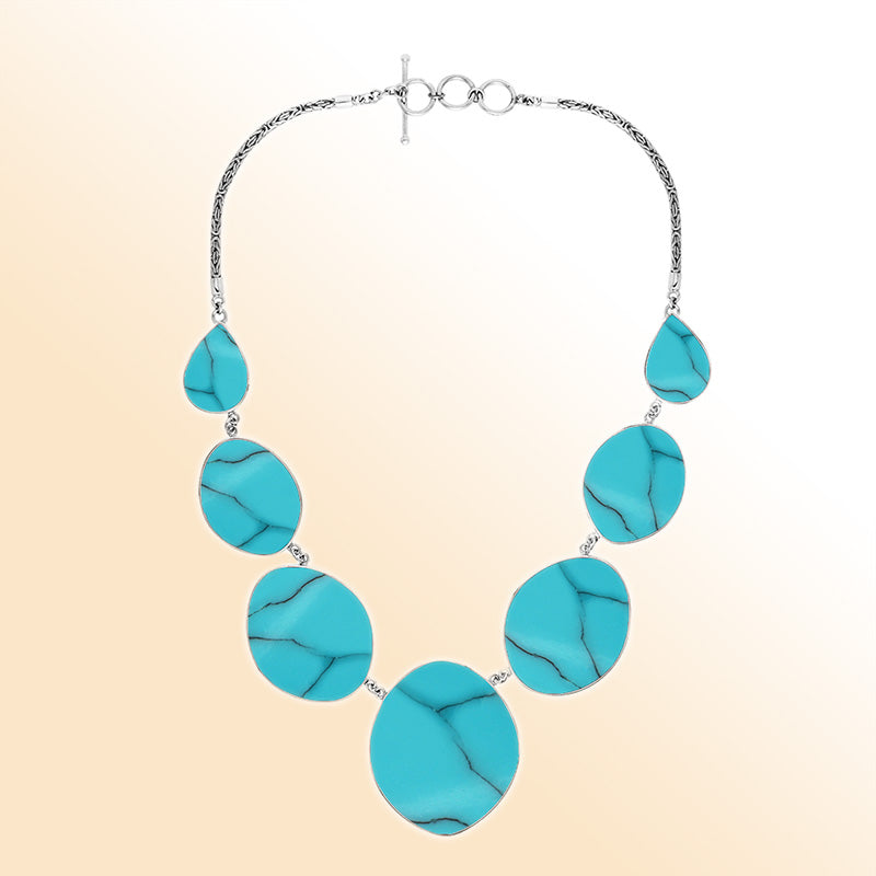 Handcrafted silver necklace with oval and teardrop turquoise shell links, ocean-inspired statement design.