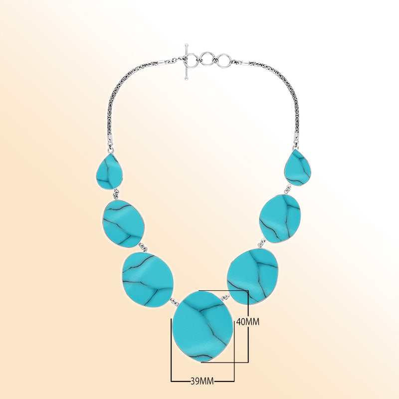 Handcrafted silver necklace with oval and teardrop turquoise shell links, ocean-inspired statement design.