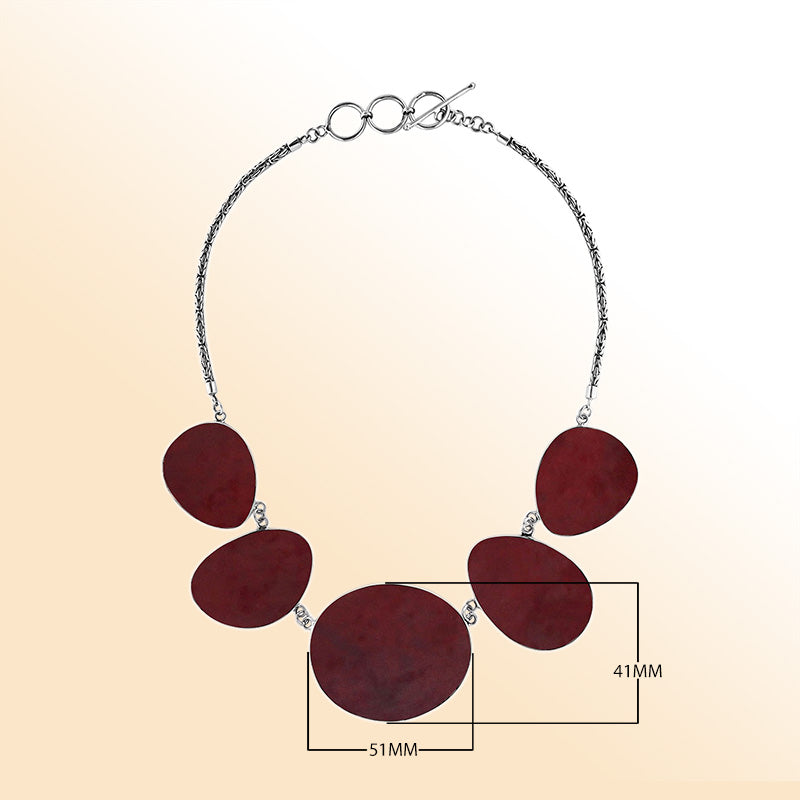 Handcrafted silver necklace with oval red coral links in elegant ocean-inspired design.