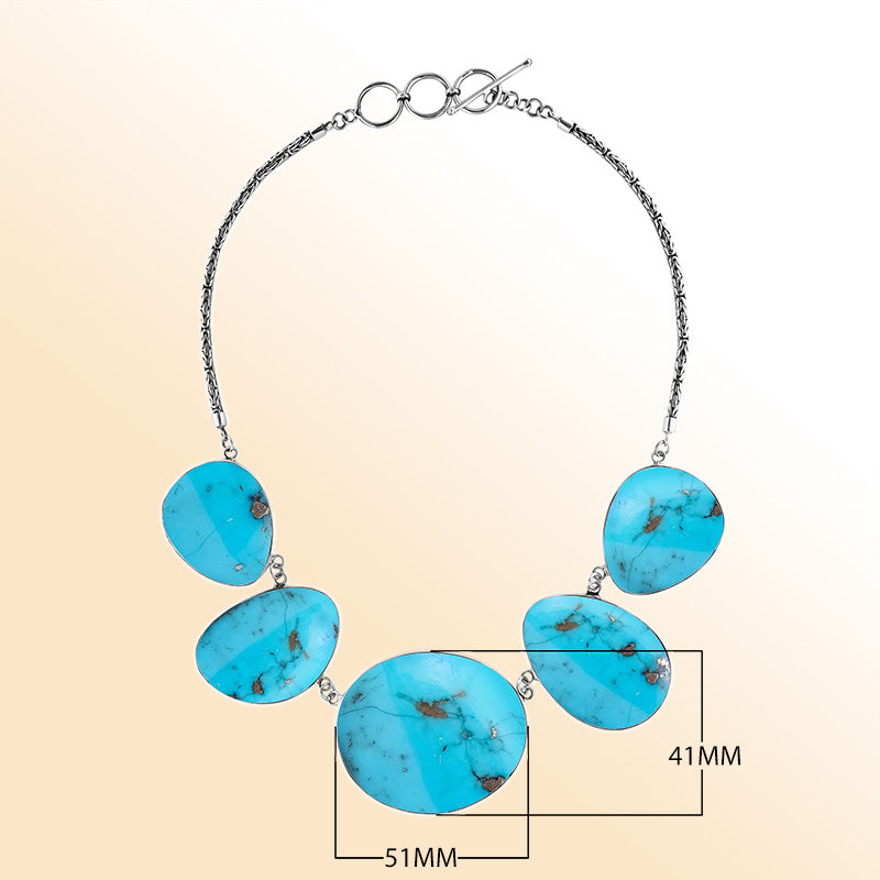 Handcrafted silver necklace with oval turquoise shell links in bold artisan design.