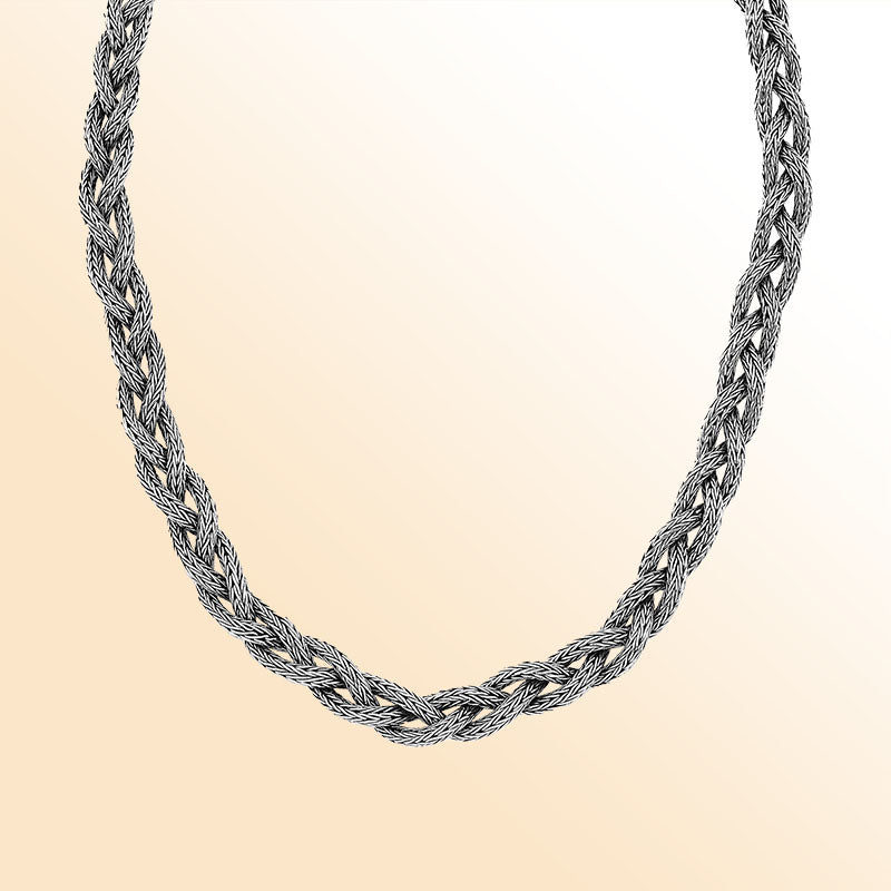 Handcrafted sterling silver braided chain necklace with ornate clasp.