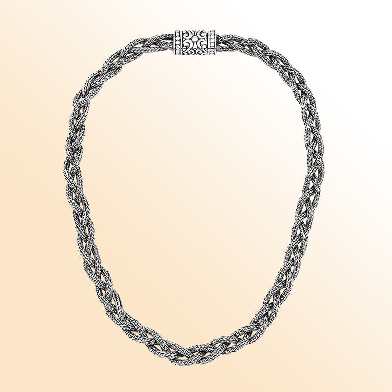 Handcrafted sterling silver braided chain necklace with ornate clasp.