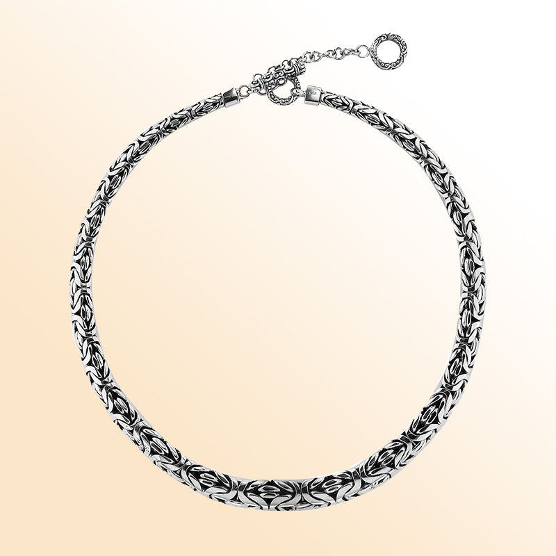 Handcrafted sterling silver graduated woven necklace with intricate design, polished-oxidized finish, and artisan clasp, made in Bali.
