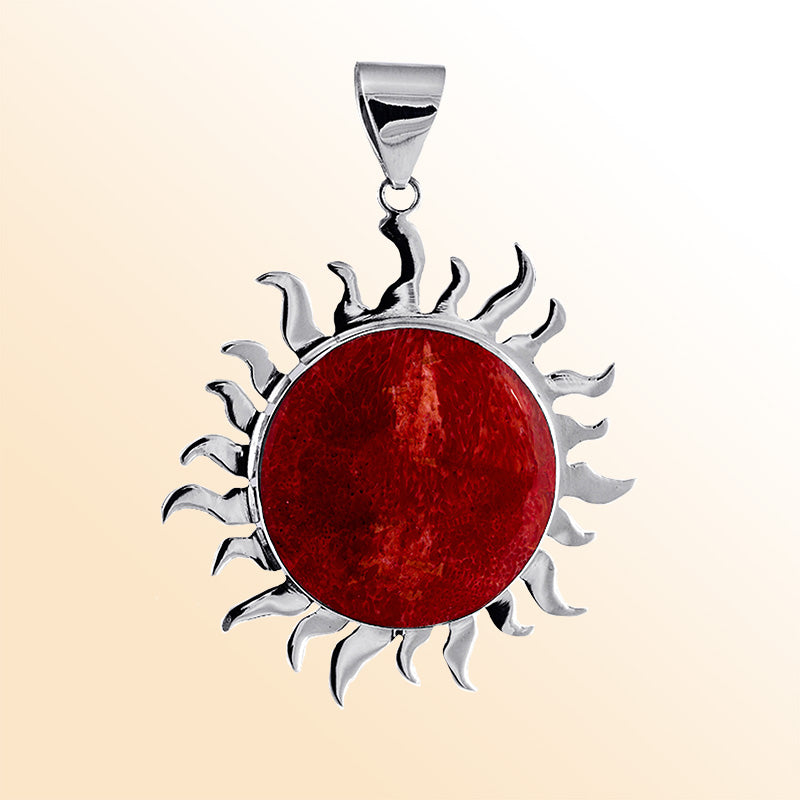 Handcrafted sterling silver sun pendant with vibrant red coral centerpiece, artisan Bali jewelry for bold everyday style.