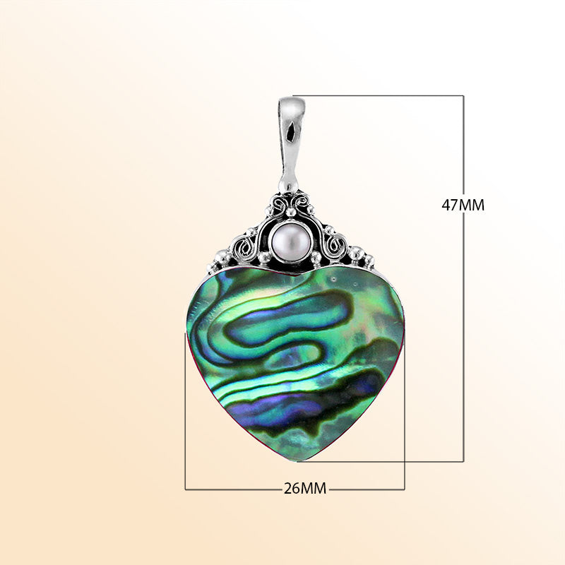 Handcrafted sterling silver heart pendant with shimmering abalone shell and luminous Fresh Water Pearl accent, artisan Bali jewelry with ocean-inspired elegance.