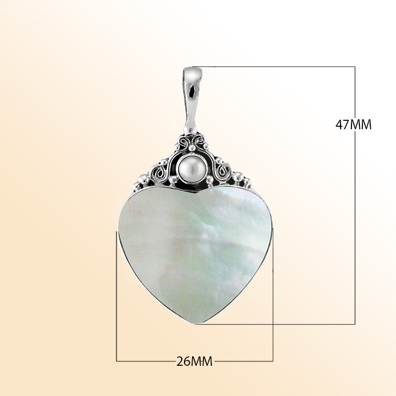 Handcrafted sterling silver heart pendant with luminous Mother of Pearl centerpiece and delicate Balinese scrollwork, artisan jewelry for timeless elegance.