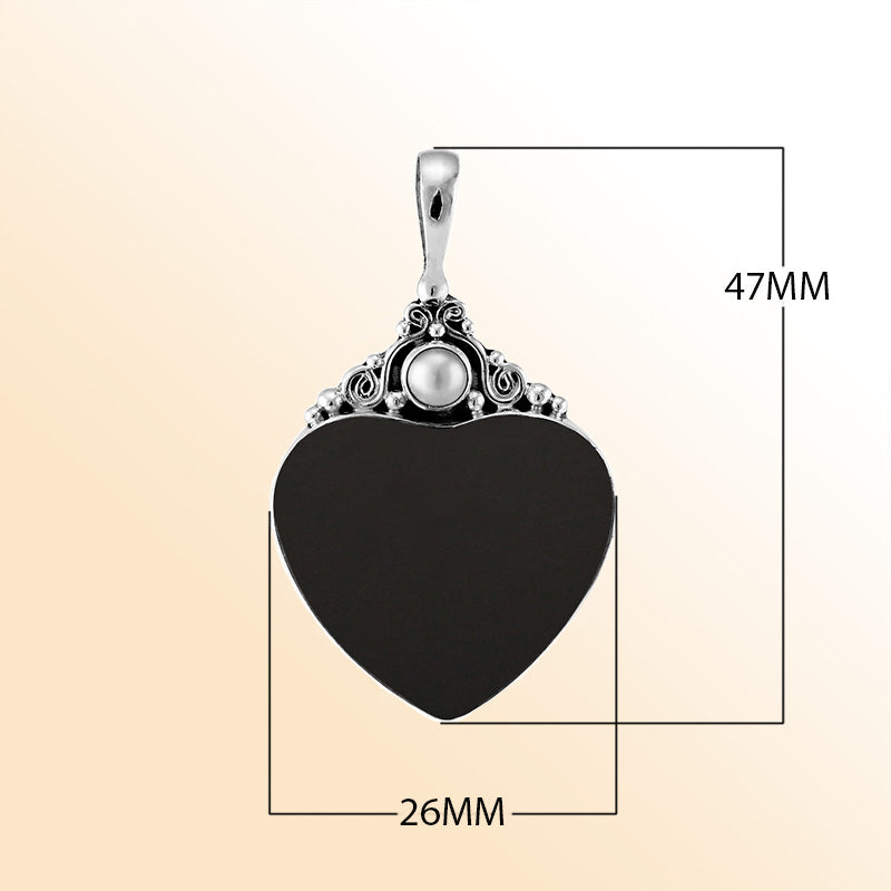 Handcrafted sterling silver heart pendant with glossy black shell and luminous Mother of Pearl accent, artisan Bali jewelry for timeless elegance.