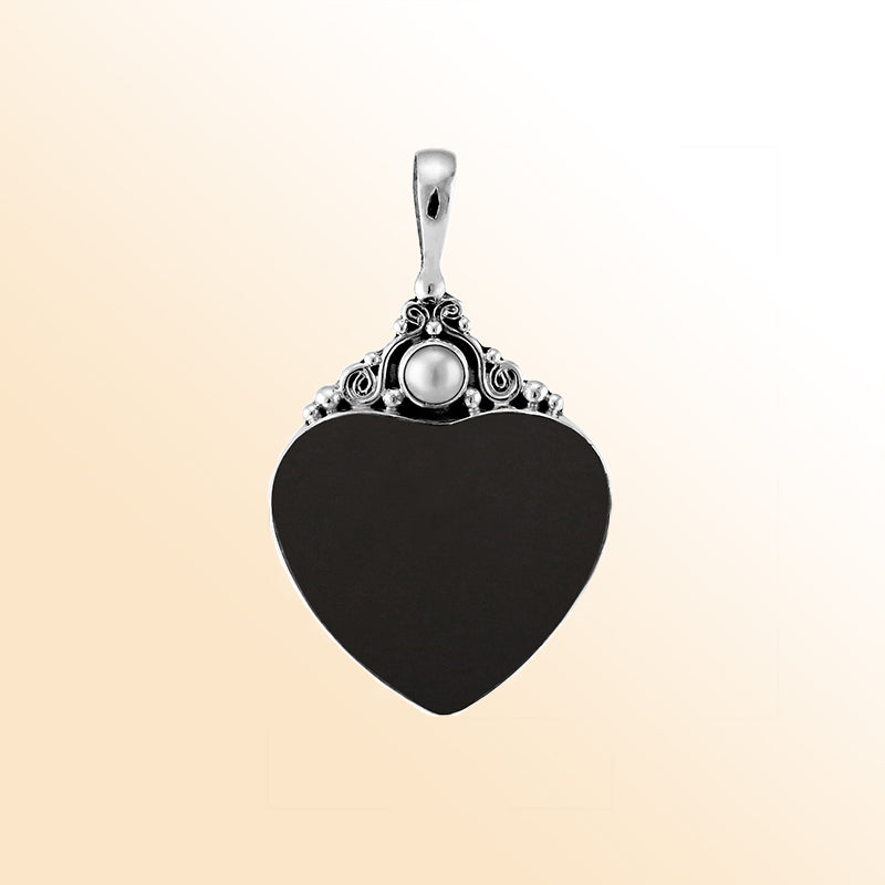 Handcrafted sterling silver heart pendant with glossy black shell and luminous Mother of Pearl accent, artisan Bali jewelry for timeless elegance.