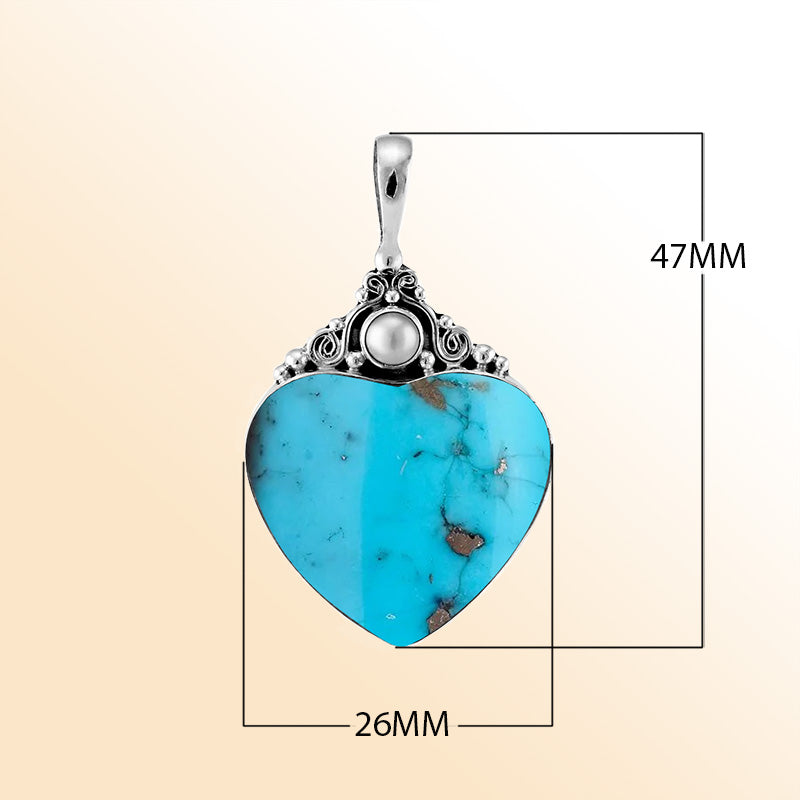 Handcrafted sterling silver heart pendant with vibrant turquoise shell and luminous Fresh Water Pearl accent, artisan Bali jewelry for timeless elegance.