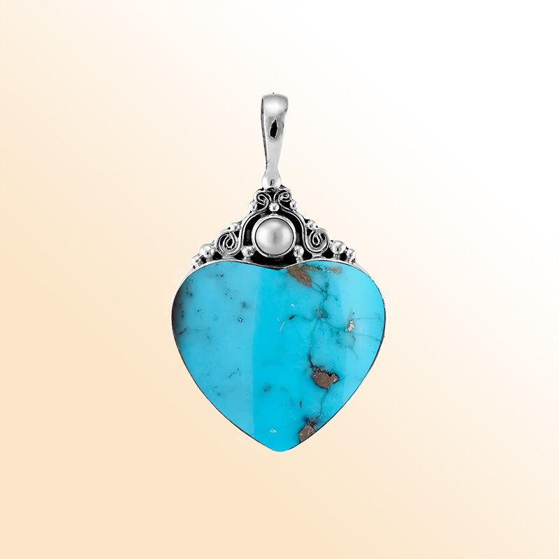 Handcrafted sterling silver heart pendant with vibrant turquoise shell and luminous Fresh Water Pearl accent, artisan Bali jewelry for timeless elegance.