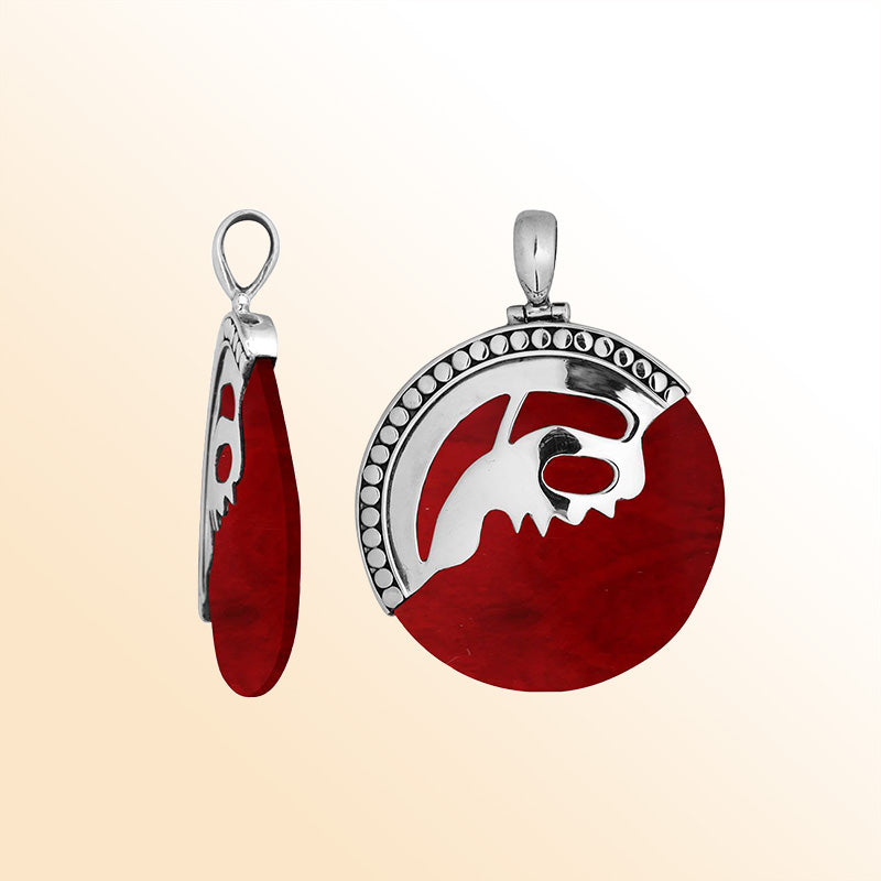 Handcrafted sterling silver round pendant with vibrant red coral inlay and unique silver overlay design, artisan Bali jewelry for bold everyday style. 