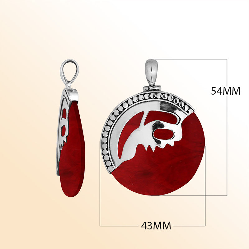 Handcrafted sterling silver round pendant with vibrant red coral inlay and unique silver overlay design, artisan Bali jewelry for bold everyday style. 
