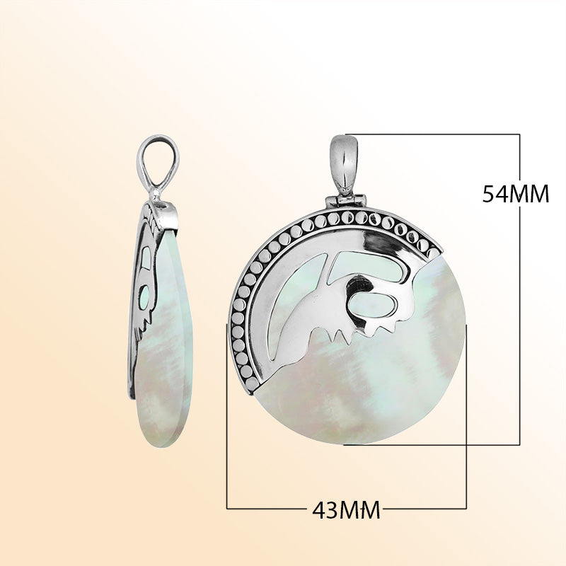 Handcrafted sterling silver round pendant with luminous Mother of Pearl inlay and unique silver overlay design, artisan Bali jewelry for timeless elegance.