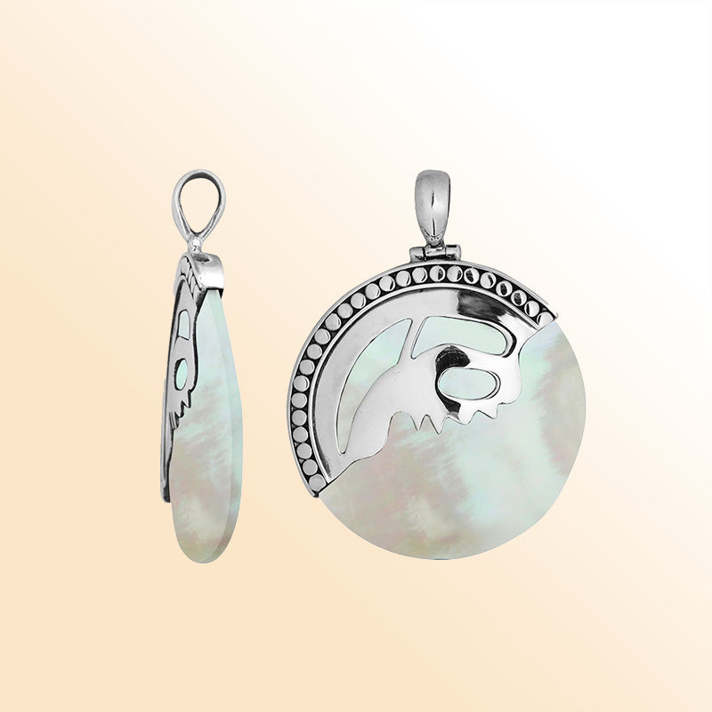 Handcrafted sterling silver round pendant with luminous Mother of Pearl inlay and unique silver overlay design, artisan Bali jewelry for timeless elegance.