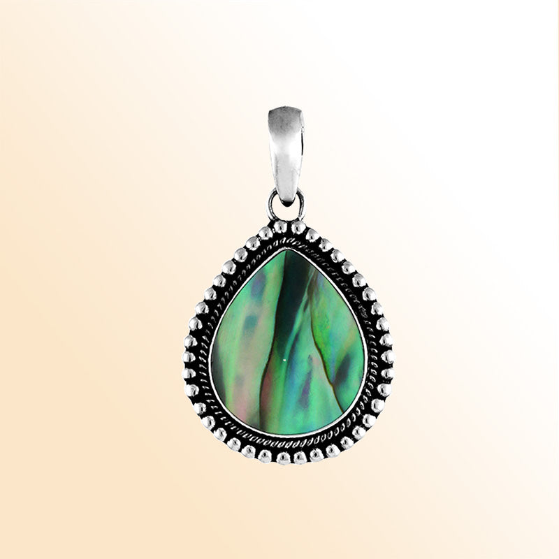 Handcrafted sterling silver pear-shaped pendant with vibrant abalone shell centerpiece, accented with a granulated rope design, artisan Bali jewelry for everyday elegance.