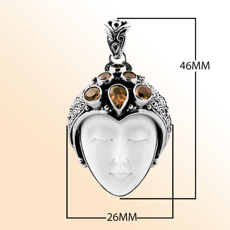 Handcrafted sterling silver pendant featuring a serene goddess face carved from bone with sparkling citrine gemstones, Balinese artisan jewelry for women.