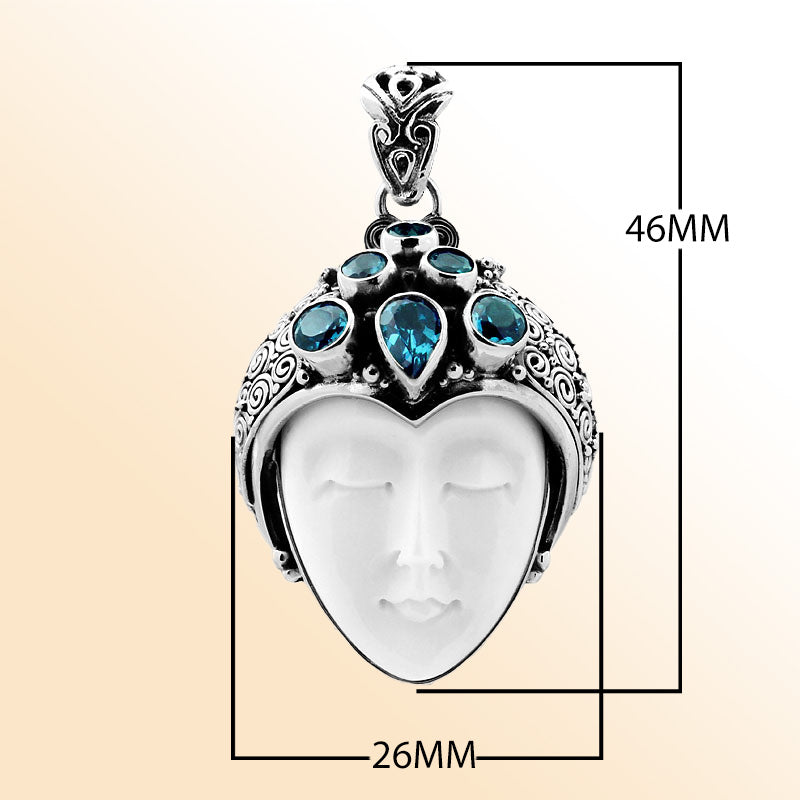 Wholesale sterling silver pendant with hand-carved bone goddess face and faceted blue topaz gemstones, handcrafted Balinese artisan jewelry design.