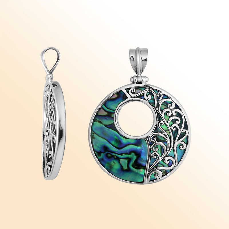 Sterling silver round Abalone shell pendant with vibrant blue-green inlay, Bali-inspired vine detailing and oxidized finish, handcrafted artisan jewelry for women.