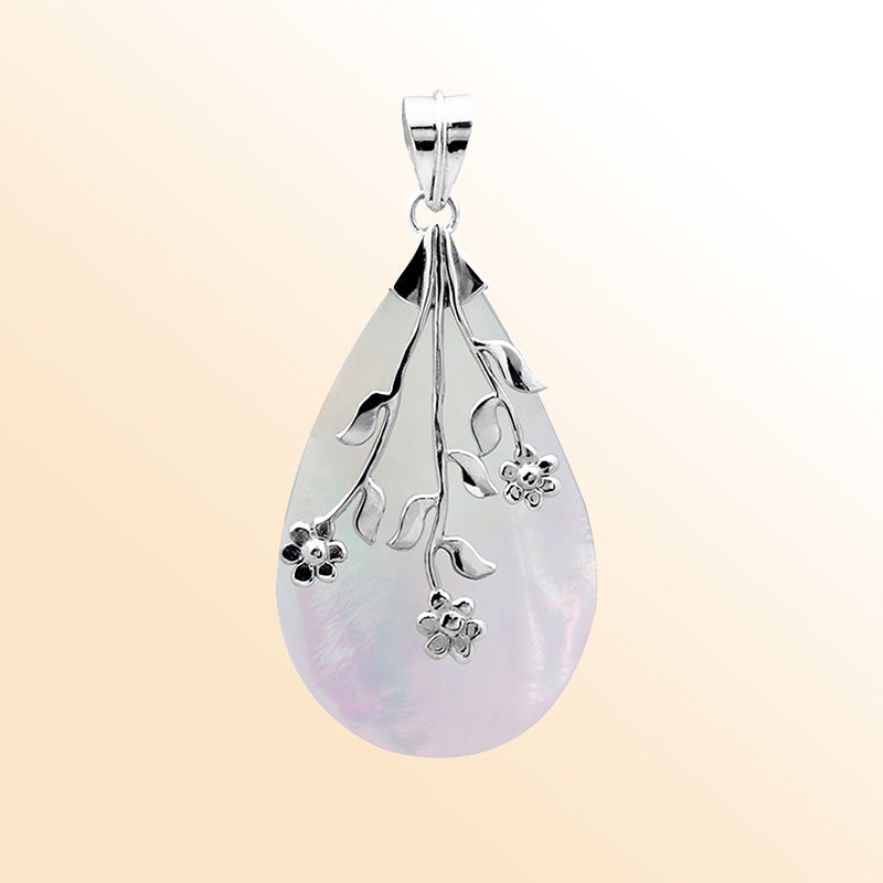 Elegant Sterling Silver Mother Of Pearl teardrop pendant with floral branch overlay, handcrafted mirror-polished finish, and luminous white sheen for women’s artistic jewelry collections.