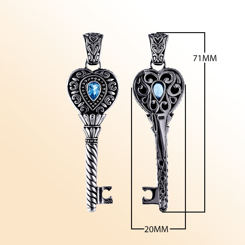 Sterling silver heart key pendant with genuine blue topaz gemstone and detailed Balinese scrollwork, handcrafted artisan jewelry for gifting or everyday wear.