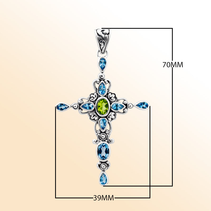 Sterling silver cross pendant with vibrant peridot quartz center and sparkling blue topaz quartz accents, handcrafted Balinese jewelry for faith-inspired style and gifting.