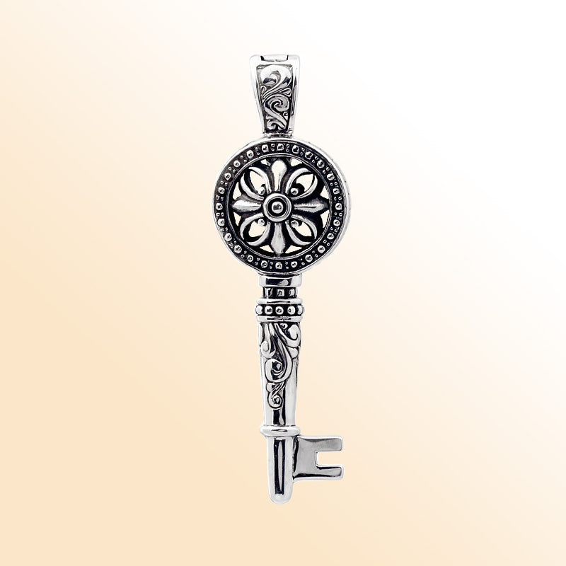 Sterling silver key pendant with handcrafted Bali floral design – symbolic jewelry gift of love, luck, and new beginnings