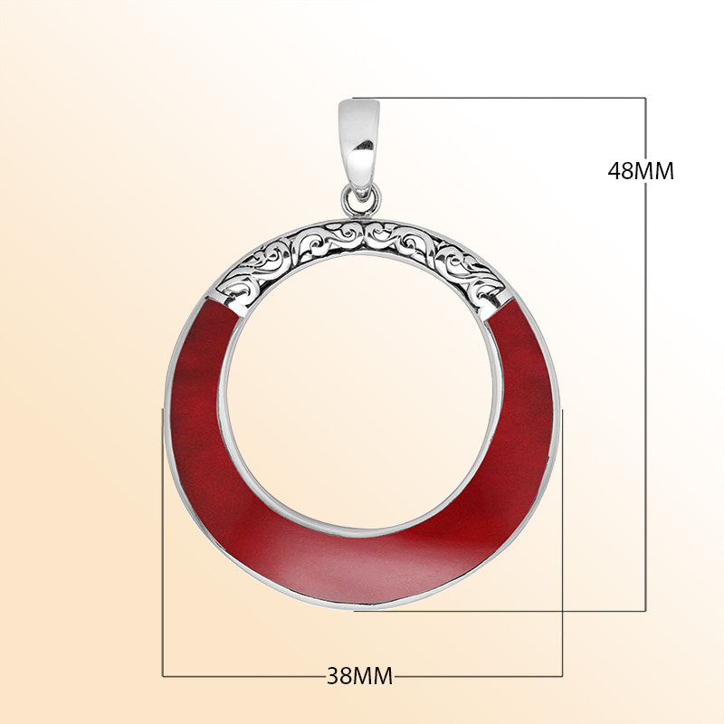 Round red coral pendant in sterling silver with open circle design and ornate detailing, handcrafted artisan jewelry