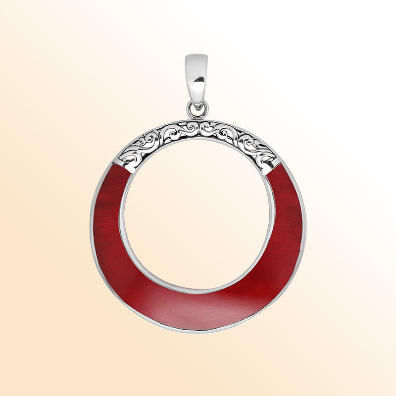 Round red coral pendant in sterling silver with open circle design and ornate detailing, handcrafted artisan jewelry
