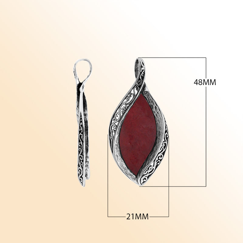 Sterling silver marquise pendant with vibrant red coral inlay and detailed Balinese carving, handcrafted in Bali.