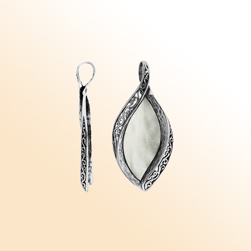 Sterling silver marquise pendant with luminous Mother of Pearl inlay and detailed Balinese carving, handcrafted in Bali.
