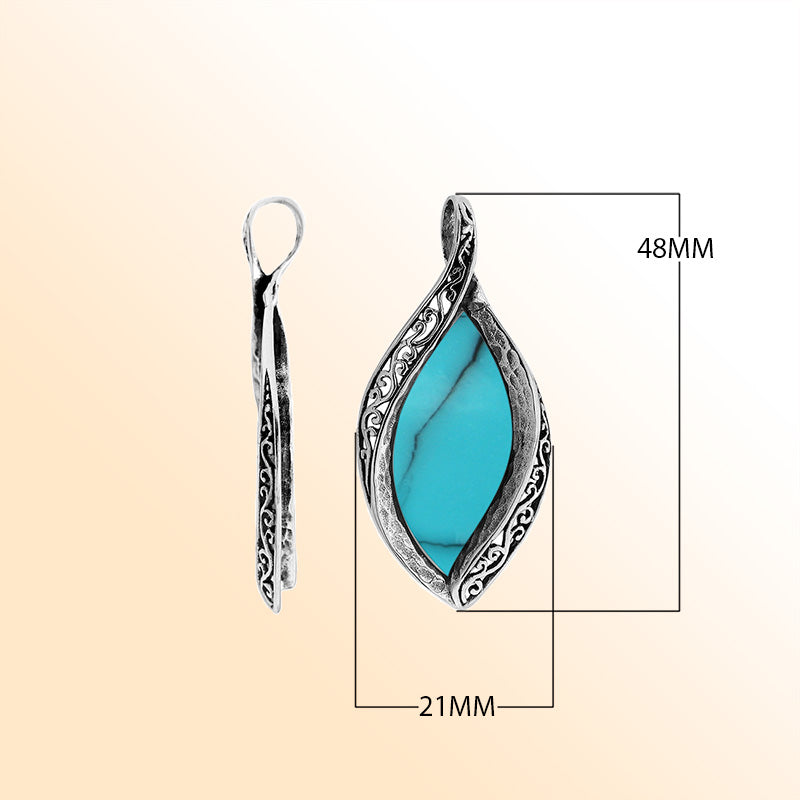 Sterling silver marquise pendant with vibrant turquoise inlay and ornate Balinese carving, handcrafted in Bali.