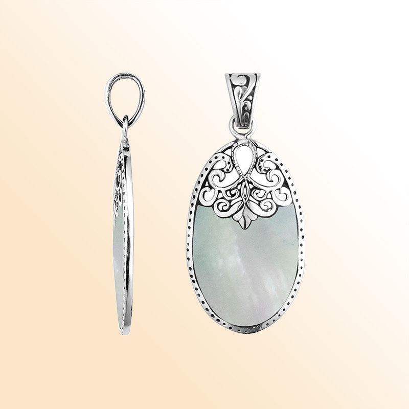 Sterling silver oval pendant with luminous Mother of Pearl inlay and delicate Balinese filigree design, handcrafted in Bali.