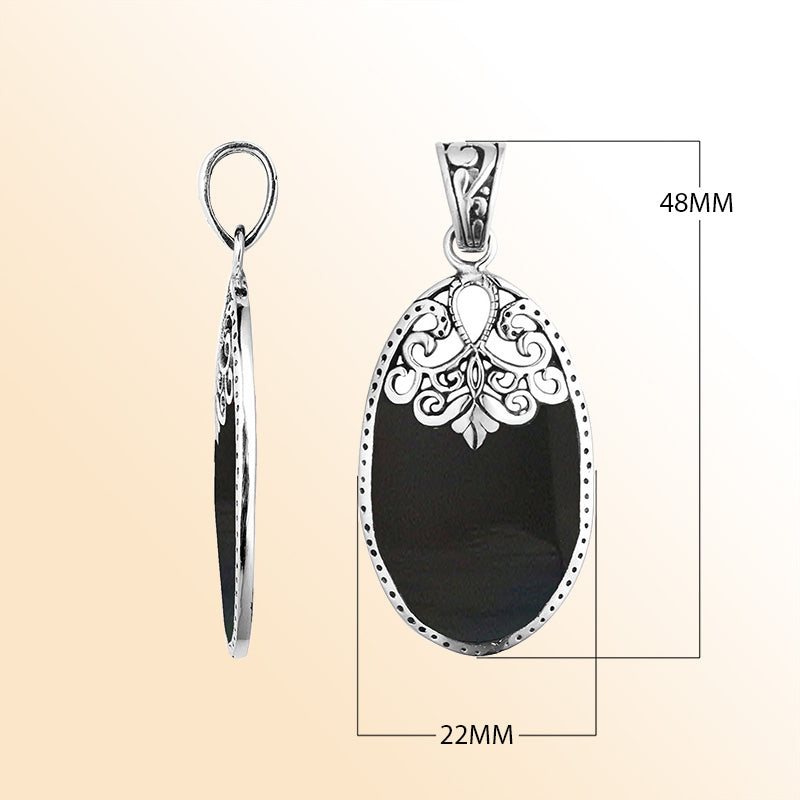 Sterling silver oval pendant with black shell inlay and delicate Balinese filigree design, handcrafted in Bali. 