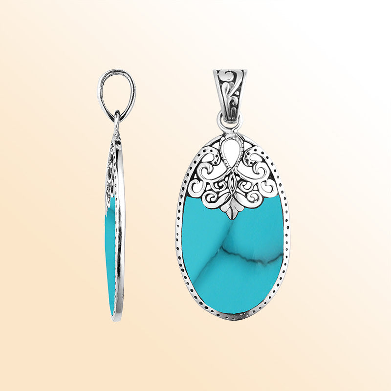 Sterling silver oval pendant with vibrant turquoise inlay and delicate Balinese filigree design, handcrafted in Bali.