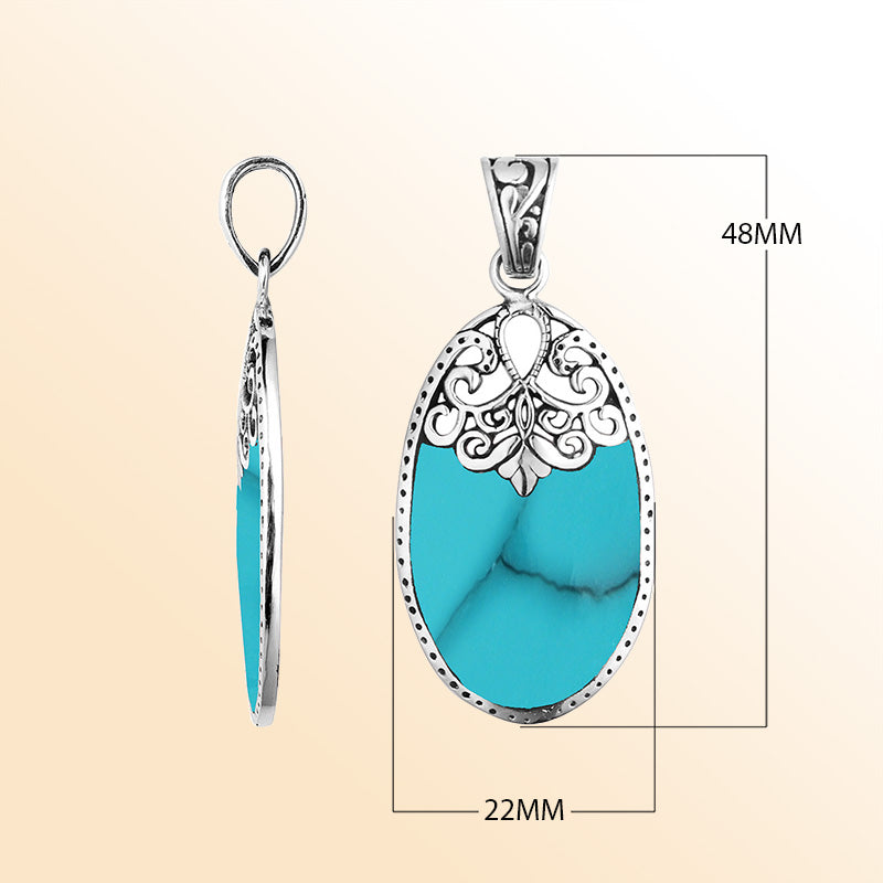 Sterling silver oval pendant with vibrant turquoise inlay and delicate Balinese filigree design, handcrafted in Bali.