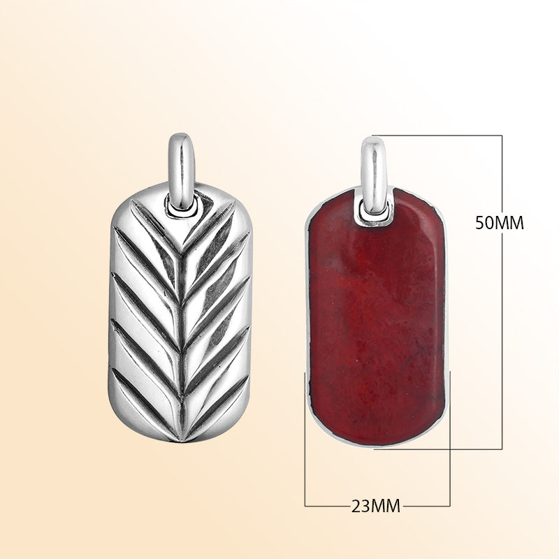 Sterling silver dog tag pendant with bold red coral inlay and reversible chevron silver design, handcrafted in Bali.