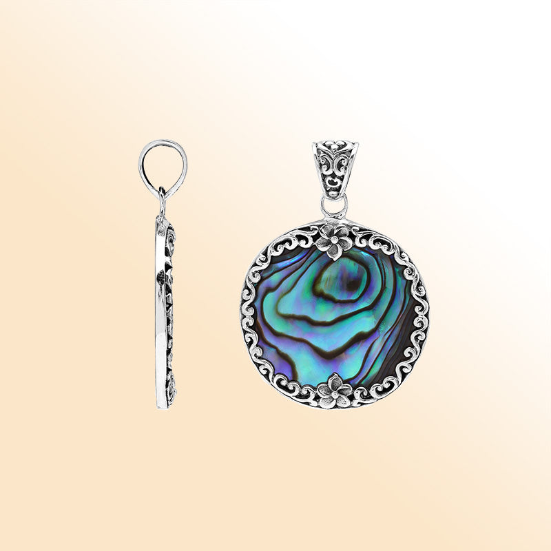 Sterling silver round pendant with shimmering abalone shell and floral detailing, handcrafted Bali artisan jewelry for elegant everyday wear.