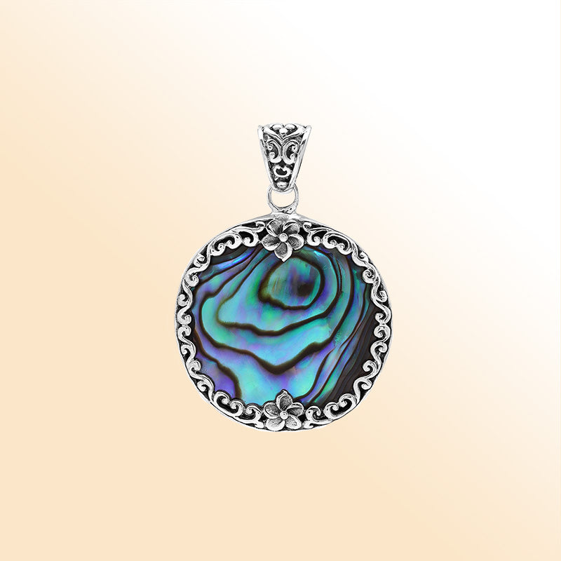 Sterling silver round pendant with shimmering abalone shell and floral detailing, handcrafted Bali artisan jewelry for elegant everyday wear.