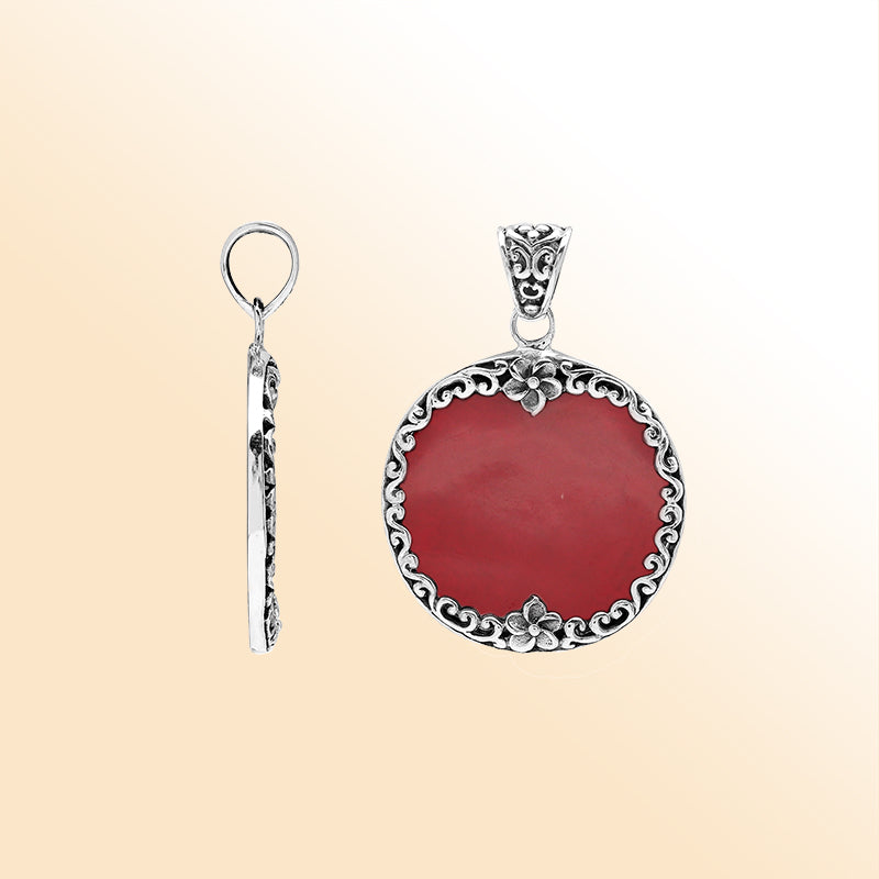 Sterling silver pendant with round red coral gemstone and floral Bali frame, handcrafted artisan jewelry for elegant everyday wear.