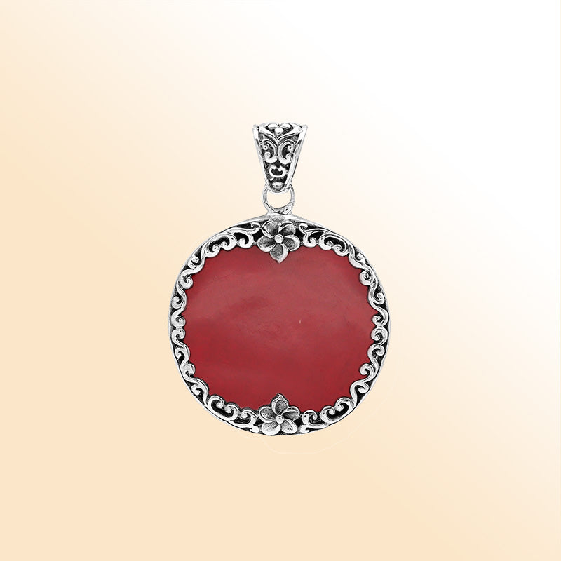 Sterling silver pendant with round red coral gemstone and floral Bali frame, handcrafted artisan jewelry for elegant everyday wear.